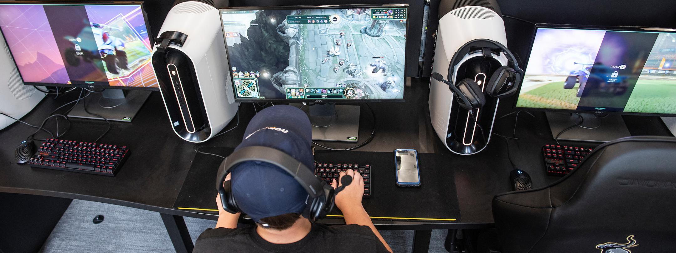 Student playing a video game in the esports lab.